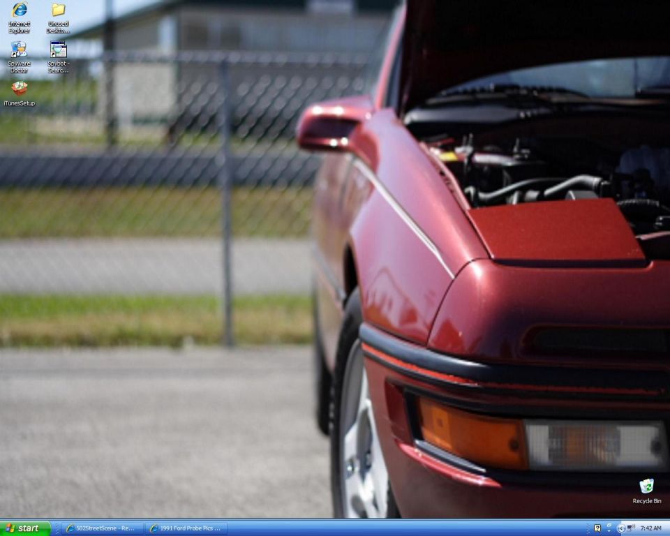 Red 1991 Ford Probe with hood open, front quarter view