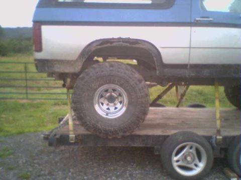 1985 Ford Bronco - This 1985 Ford Bronco is seen from the side, loaded onto a trailer for transport.