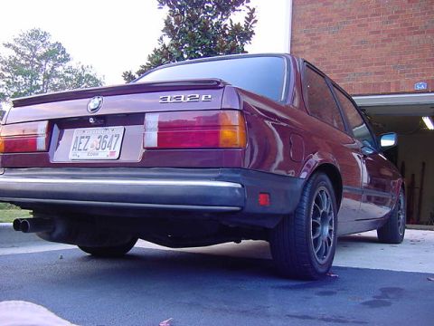 1984 BMW 3 Series - Rear view of a 1984 BMW 3 Series coupe parked in front of a garage.