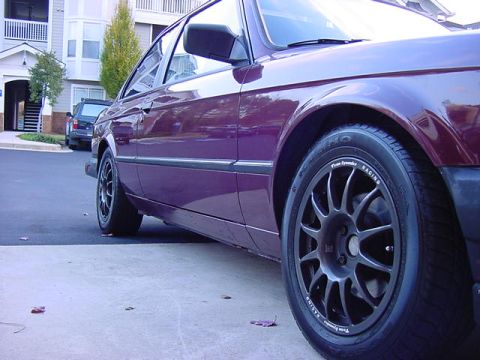 1984 BMW 3 Series - A purple BMW E30 coupe is shown from the side, aftermarket wheels and a clean body style.