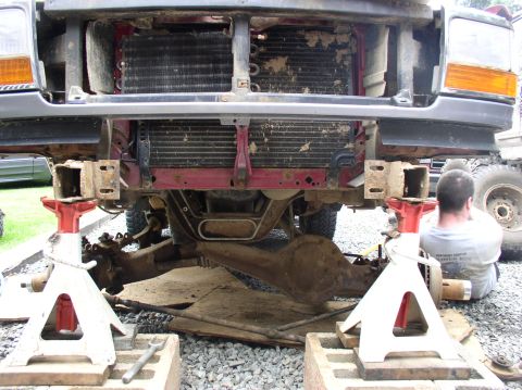 1996 Ford F-250 - Front view of a 1996 Ford F-250 undergoing maintenance, with the front end elevated on jack stands.