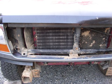 1996 Ford F-250 - The front of a truck is shown with the radiator and cooling fins exposed. The bumper is missing.