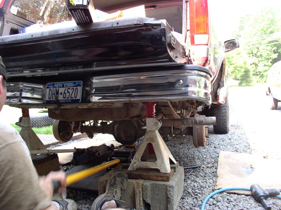 1996 Ford F-250 rear axle and bumper on jack stands, New York license plate DHM-6520 visible