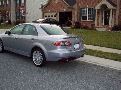 2006 Mazda 6 - Silver 2006 Mazda 6 sedan parked on a street in front of houses.