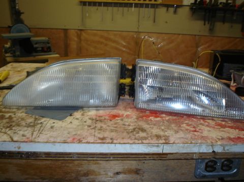 1978 Ford Mustang II - A pair of headlight assemblies are laid out on a patterned surface, possibly for repair or replacement.