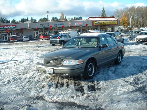 2000 Ford Crown Victoria - This 2000 Ford Crown Victoria is parked in a snowy lot with a commercial building in the background.
