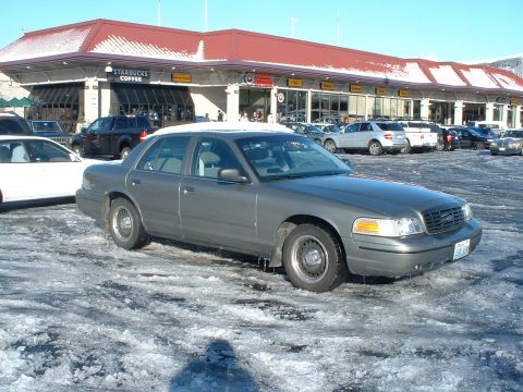 2000 Ford Crown Victoria - A 2000 Ford Crown Victoria is parked in a snowy lot with a Starbucks in the background.