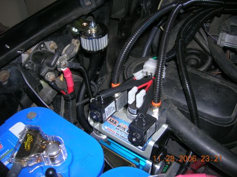 1996 Ford Bronco - Vehicle engine bay shows an ARB air compressor, battery, and various electrical connections.