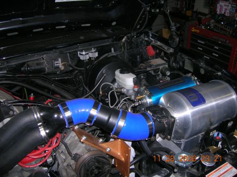 1996 Ford Bronco - Custom engine bay modifications include a large air intake system with blue silicone hoses and a prominent silver air filter housing.