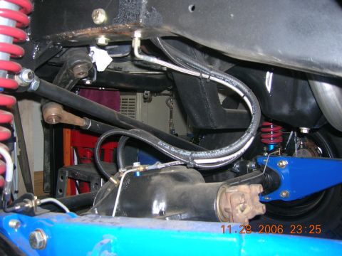 1996 Ford Bronco - Close-up of vehicle undercarriage with custom suspension and brake lines visible.