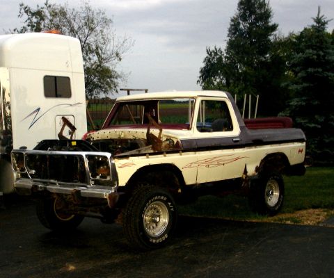 1979 Ford Bronco - This 1979 Ford Bronco, seen with its hood open, shows significant rust on its body panels.