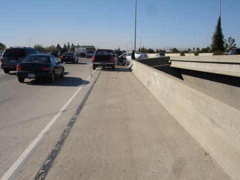 1993 Ford Taurus - A multi-vehicle accident has occurred on the freeway, blocking traffic and causing a standstill.