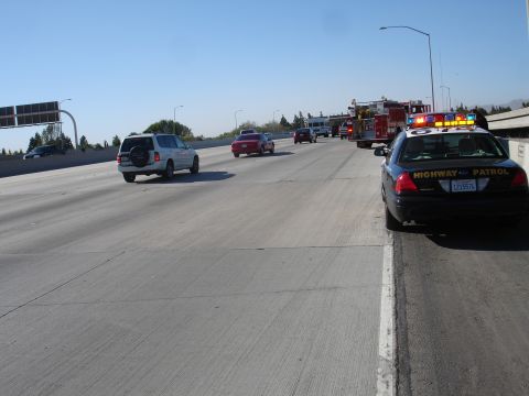 1993 Ford Taurus - Emergency vehicles respond to a scene on a sunny day on the freeway.