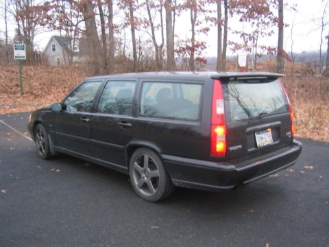 1993 Ford Probe - This black Volvo wagon is seen from the rear, a spoiler and aftermarket wheels.