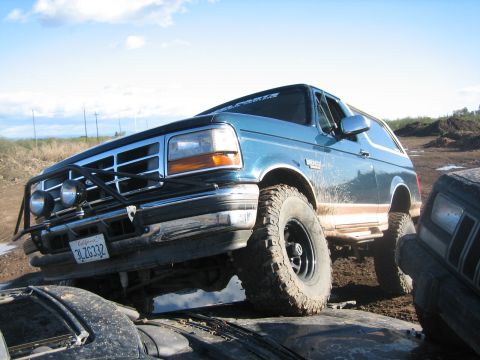 1995 Ford Bronco - This 1995 Ford Bronco, equipped with a brush guard and aggressive off-road tires, tackles a challenging course.