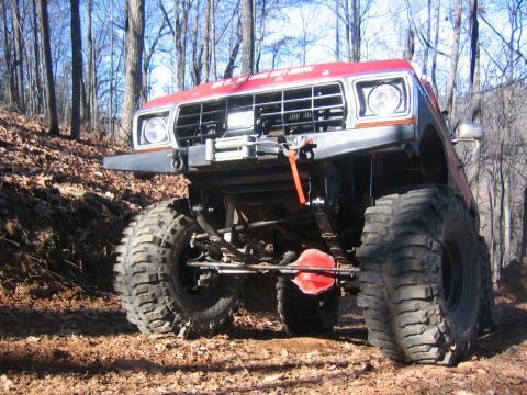 1979 Ford Bronco - Customized 1978 Ford Bronco tackling an off-road trail with oversized tires.