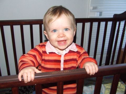 1990 Ford Bronco - A smiling baby is pictured inside a wooden crib, with the brand name 'storkcraft' visible on the railing.