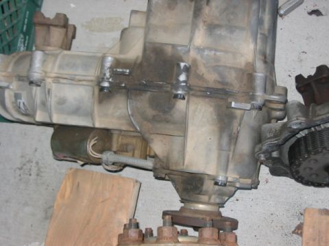1991 Ford Bronco - A transfer case, likely from a 4x4 vehicle, is shown with its chain drive mechanism visible.