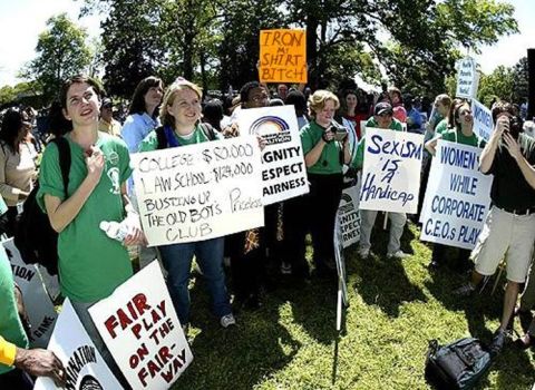 1978 Ford Mustang II - Protestors hold signs with various messages during an outdoor demonstration.