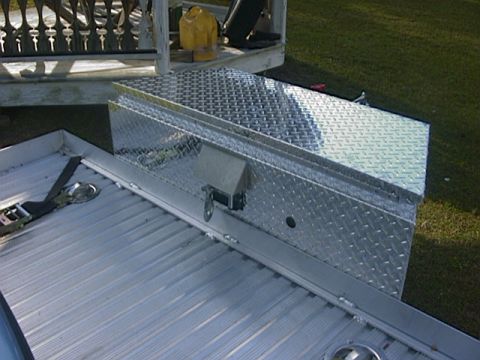 1990 Ford Mustang - Diamond plate toolbox secured on a trailer bed, with a yellow gas can visible in the background.