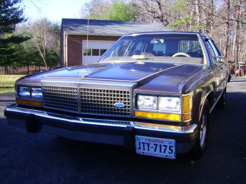 1982 Ford Crown Victoria LTD - A brown 1982 Ford Crown Victoria LTD is parked in front of a garage.