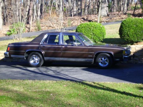 1982 Ford Crown Victoria LTD - This 1982 Ford Crown Victoria LTD is seen from the side, parked on a driveway.