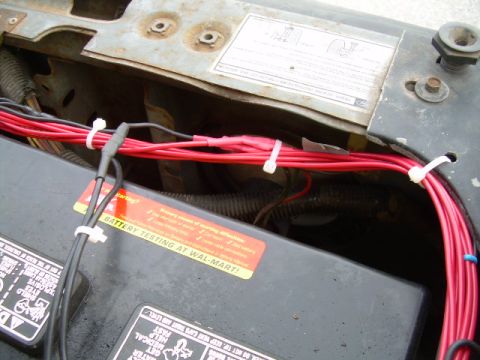 1988 Ford Bronco - Wiring is being routed through the engine bay, near the battery.
