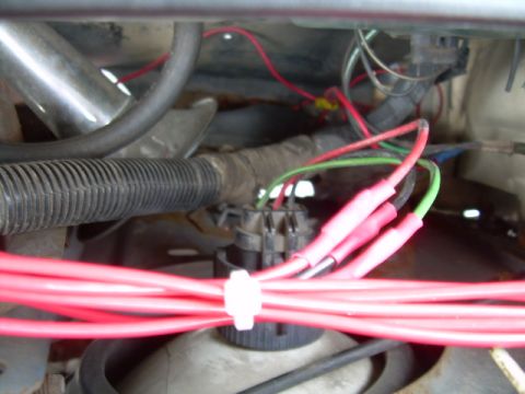 1988 Ford Bronco - Close-up of an engine wiring harness showing red and green wires connected to a junction block.