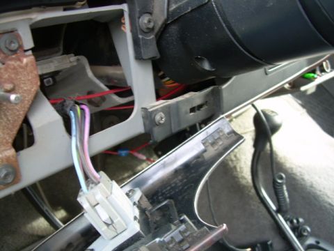 1988 Ford Bronco - The dashboard wiring harness is exposed, showing multiple colored wires connected to a white connector.