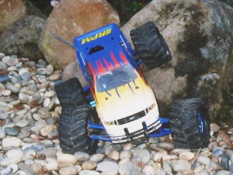 1995 Ford Bronco - This remote control monster truck, marked 'RPM', is pictured navigating a rocky terrain.