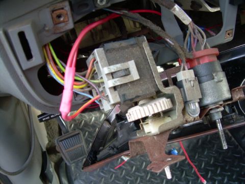1988 Ford Bronco - The complex wiring and components of a vehicle's steering column are visible in this close-up shot.