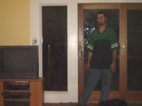 1992 Ford Bronco - A man stands in a doorway next to a television set.