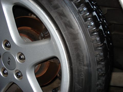 1998 Ford Taurus - A close-up view of a wheel an SVT badge and a tire with visible text.