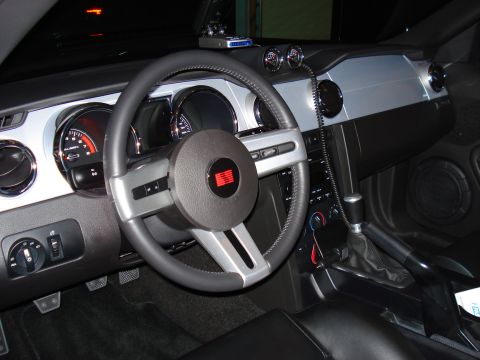 1998 Ford Taurus - The interior of a car is visible, the steering wheel, instrument cluster, and center console.