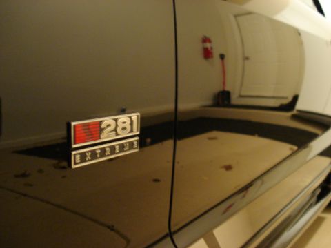 1998 Ford Taurus - A close-up of a "281 EXTREME" emblem on the side of a black vehicle.