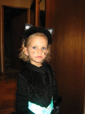 1976 Ford F-150 - A young child dressed as a cat for Halloween, complete with ears and whiskers.