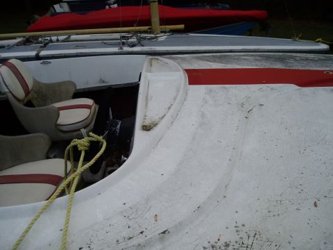 1978 Ford F-250 - The interior of a boat is visible, two seats and a yellow rope. Other boats are seen in the background.