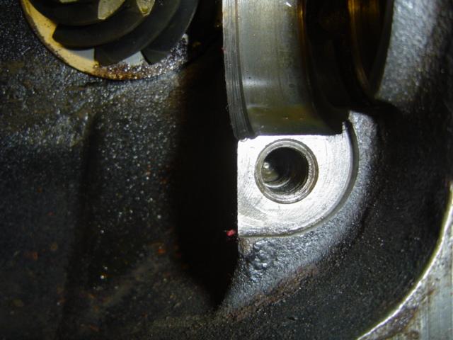 Close-up of engine part with visible gears and oil