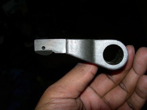1992 Ford Taurus - Close-up of an unidentified metal automotive part being held.