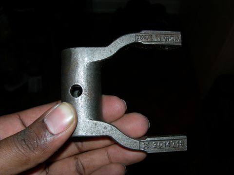 1992 Ford Taurus - A metal automotive part is shown with 'MADE IN CHINA' and a part number stamped into its surface.