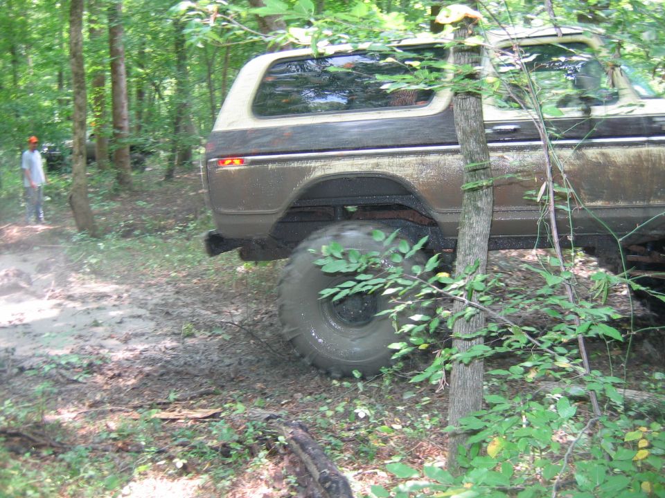 Brown and tan Ford Bronco, rear view, off-road tires