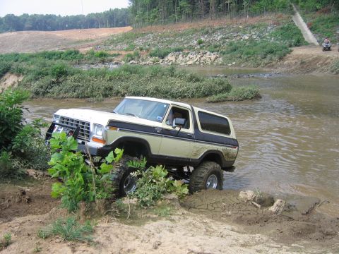 1992 Ford Mustang - This lifted Ford Bronco is navigating a muddy water crossing.