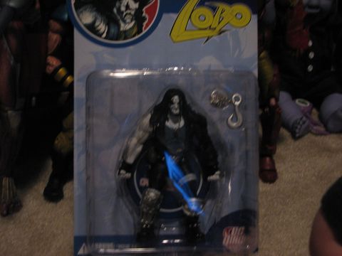 1991 Ford Bronco - This is a photo of a Lobo action figure in its original packaging, with other toys in the background.