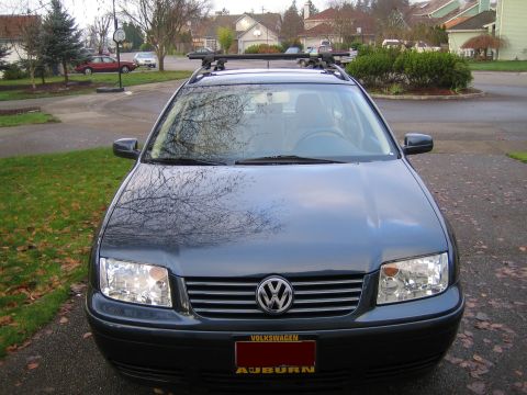 2005 Volkswagen Jetta - Dark gray 2005 Volkswagen Jetta wagon with roof rack is parked in a suburban driveway.