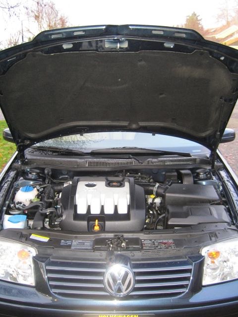 2005 Volkswagen Jetta - The engine bay of a 2005 Volkswagen Jetta is visible with the hood raised, revealing the engine components.