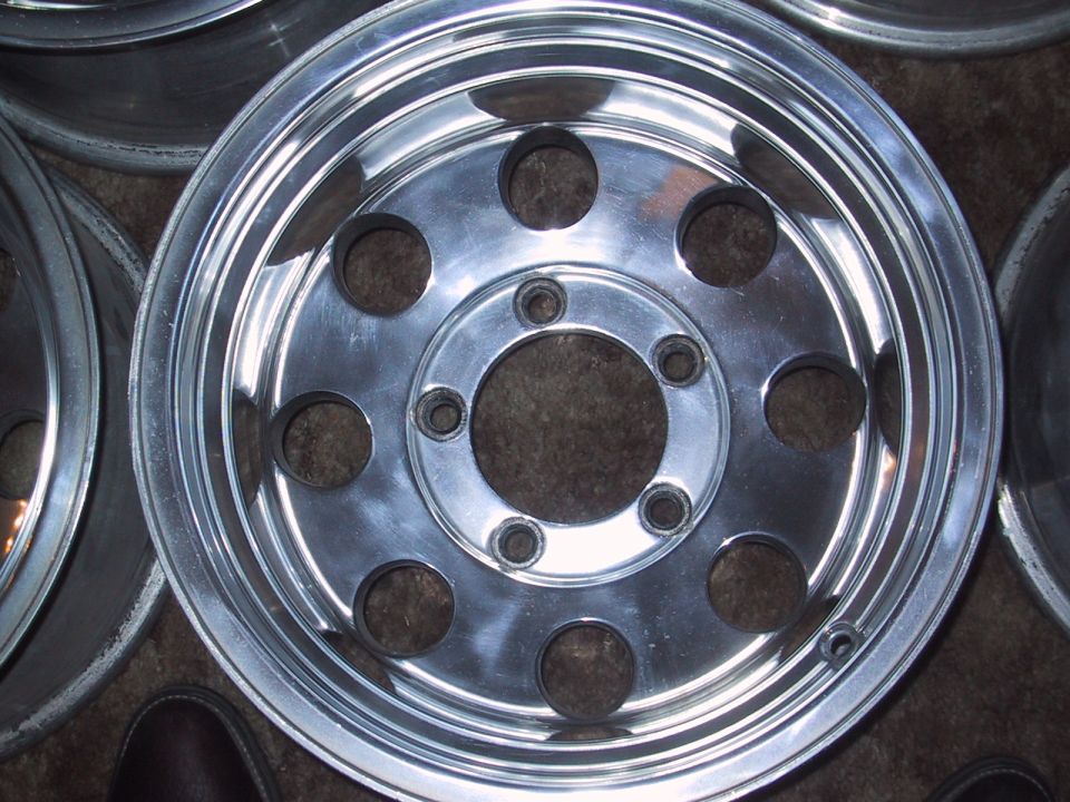 close-up of a shiny aluminum wheel with multiple lug nut holes