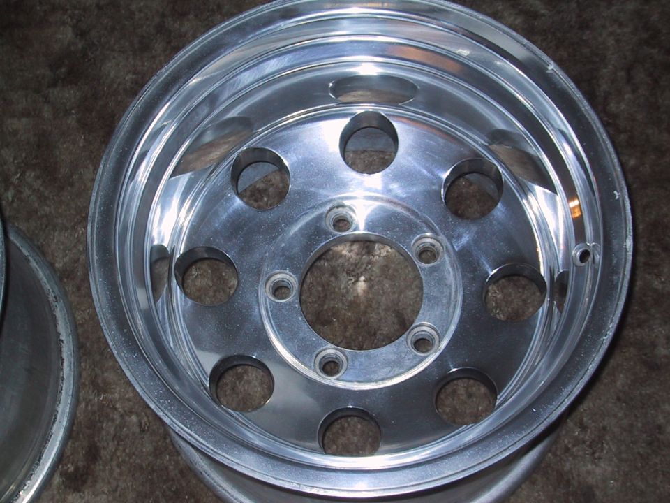 Aluminum wheel with 8 circular cutouts and 5 lug holes
