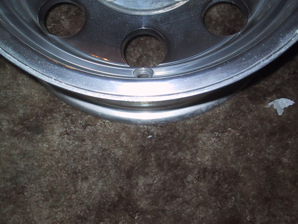 Close-up of a vehicle's aluminum wheel with lug nut holes