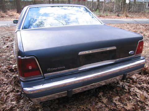 1991 Ford LTD Crown Victoria - Rear view of a 1991 Ford Crown Victoria LTD, showing its taillights and chrome bumper.
