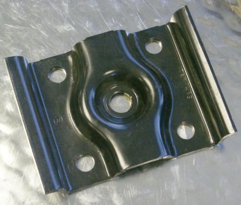 1991 Ford Bronco - A black metal bracket, possibly a suspension component, is shown against a metallic background. It features four bolt holes and a central c…